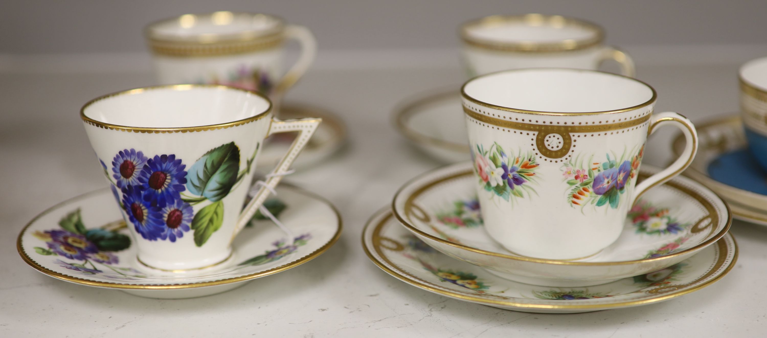 A Royal Worcester jewelled coffee cup and saucer painted with heathers by George Hundley, a Royal Worcester jewelled trio with gilt cla